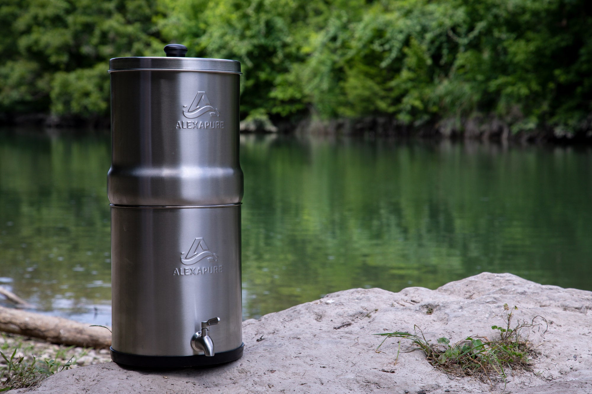 Alexapure Pro on a boulder next to a lake.