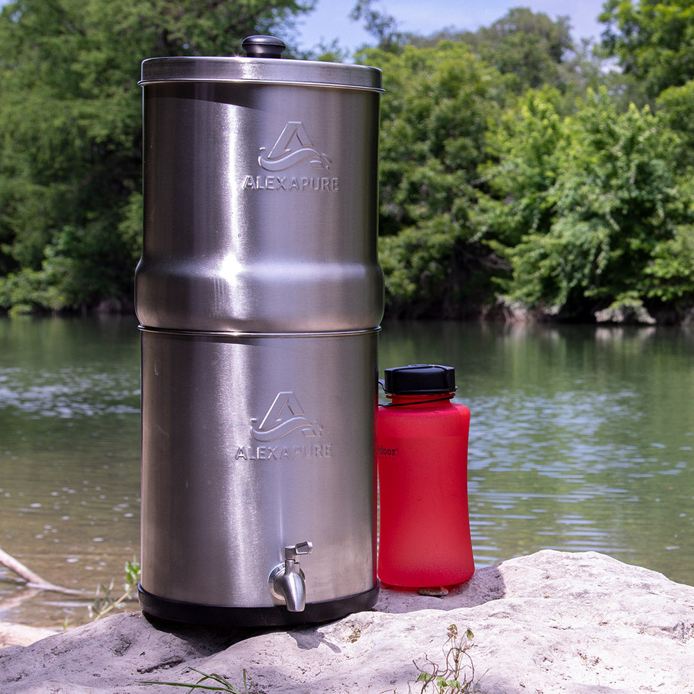 Alexapure Pro next to a lake with a sport bottle sitting next to it.